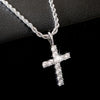 Silver cross necklace with clear stones on a black background