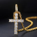 Gold cross pendant with diamonds on a dark background