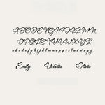 Black cursive alphabet font sample showing uppercase, lowercase, and personalized names on a light beige background.