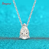 Teardrop-shaped diamond pendant on a chain against a turquoise background