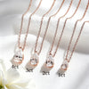 Four rose gold necklaces with pear-cut clear crystals are arranged diagonally on white satin fabric, with text labels indicating 4ct, 3ct, 2ct, and 1ct sizes.
