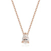 A pear-cut clear gemstone pendant necklace in a rose gold four-prong setting on a matching rose gold chain, shown against a plain white background.