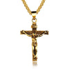 Gold crucifix pendant on a chain against a white background